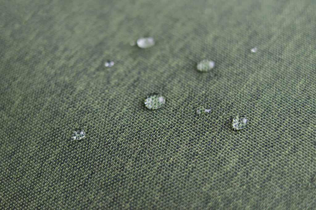 showing the Sons of Aloha Material with water drops. High quality woven material with light and dark green yarn. 100% water repellent - born for adventure
